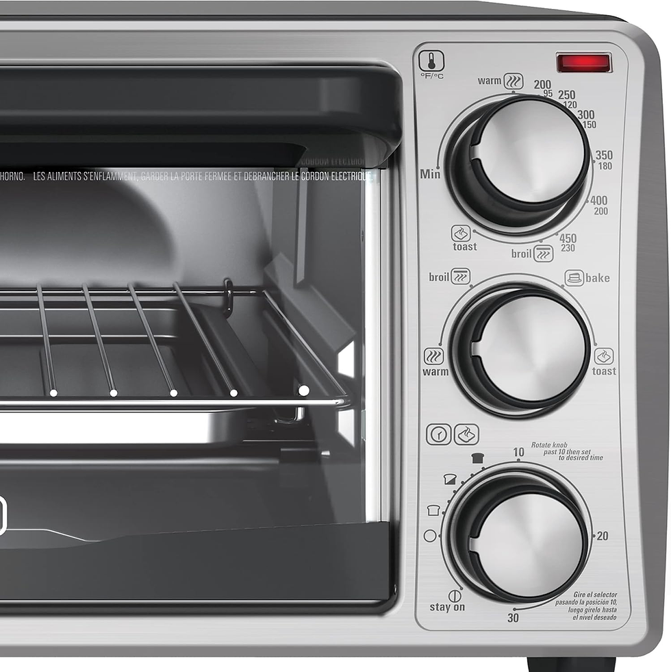Black+Decker 4-Slice toaster oven with three dials on the right for temperature and settings. Interior features a wire rack. Text in English and French.