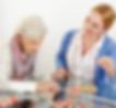 caregiver and senior playing a board game