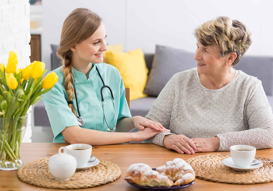 senior and caregiver having breakfast
