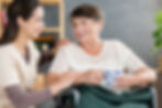 caregiver and senior smiling together