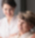 caregiver and senior looking out the window smiling