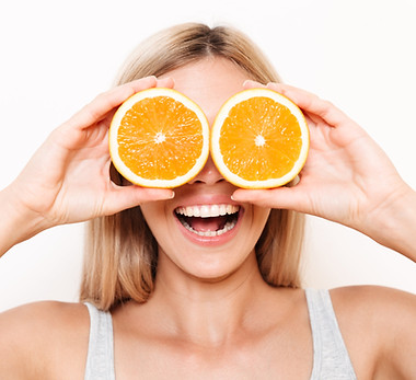portrait-cheerful-young-woman-covering-her-eyes-with-orange-fruit-min.jpg