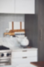 arrangement of cutting boards to the side of the range by lifestyle kitchen studio