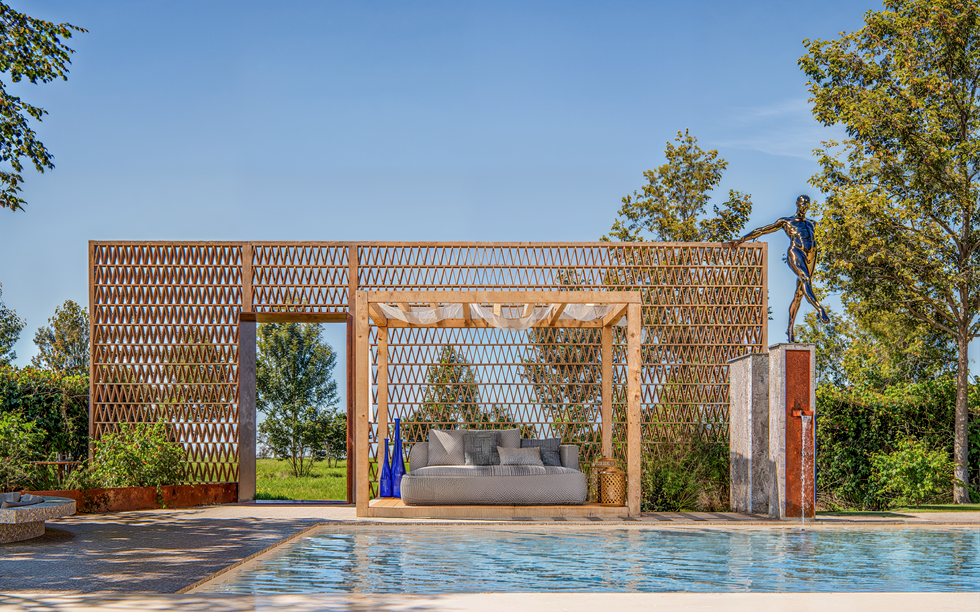 3D exterior rendering of a luxury outdoor pool and lounge area with seating, fire pit, and modern pergola.