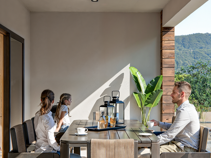 Residential building 3D exterior rendering with a family enjoying an afternoon on their balcony.