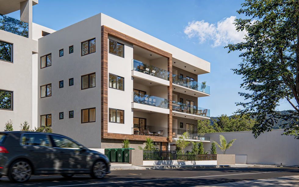 3D exterior rendering of a modern residential apartment building, showcasing balconies, wood cladding and soft natural lighting.