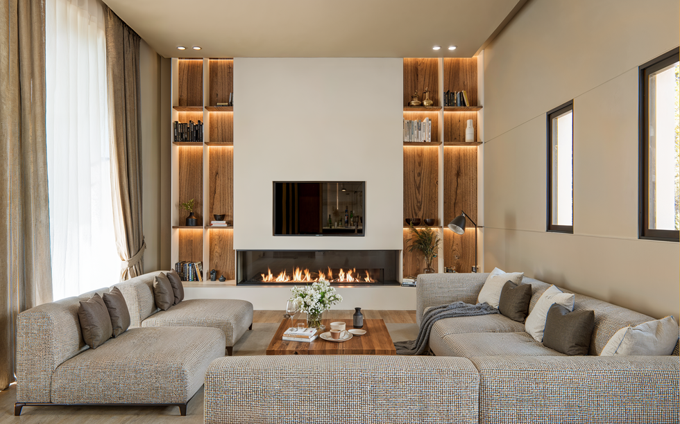 3D renderings of luxury lounge and bar area with modern fireplace, elegant lighting and cozy seating.