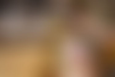 Person refills a glass jar with pasta from a bulk dispenser, showing sustainable shopping choices and cutting down on single-use plastic.