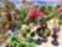 Dungeons & Dragons miniatures fight dinosaur in tropical battle map