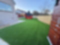 Artificial grass in a garden with play house