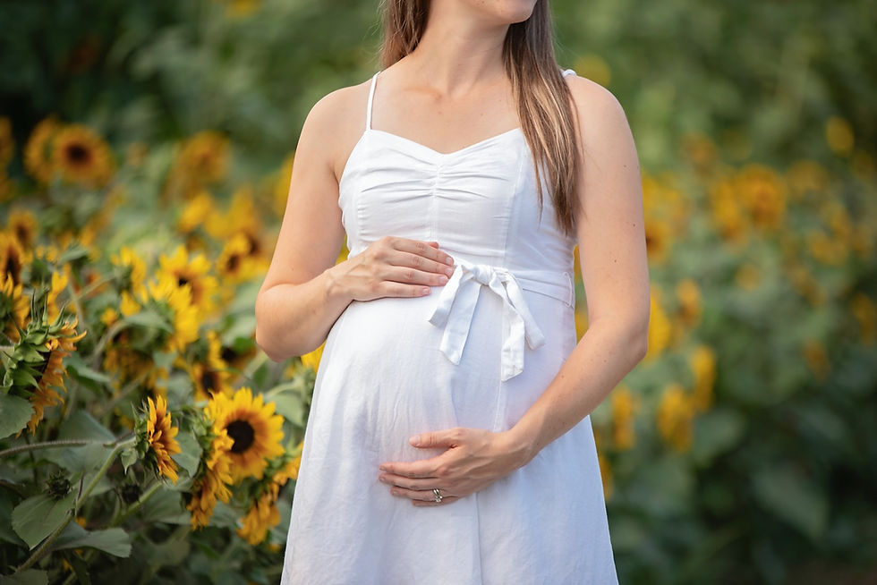 close up maternity portrait session in sunflowers