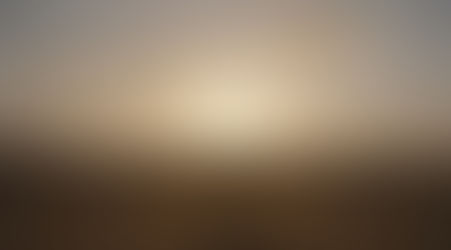 Silhouette of figure walking towards cross in desert