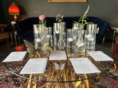 a table with seating cards and candles on it