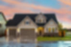 A photo of a home with a new roof in a suburban neighborhood.