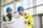 Indian architect and mature supervisor meeting at construction site. Multiethnic manual wo