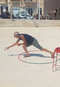 A Bocci player showing tourists how to play the popular Maltese game during the bocci experience tour