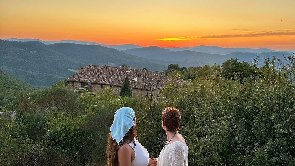 Women enjoying sunset views in Umbria during a transformative women's wellness retreat in Italy.