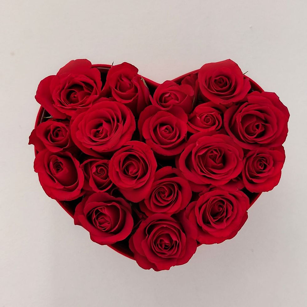 red roses in a suede heart hat box top view