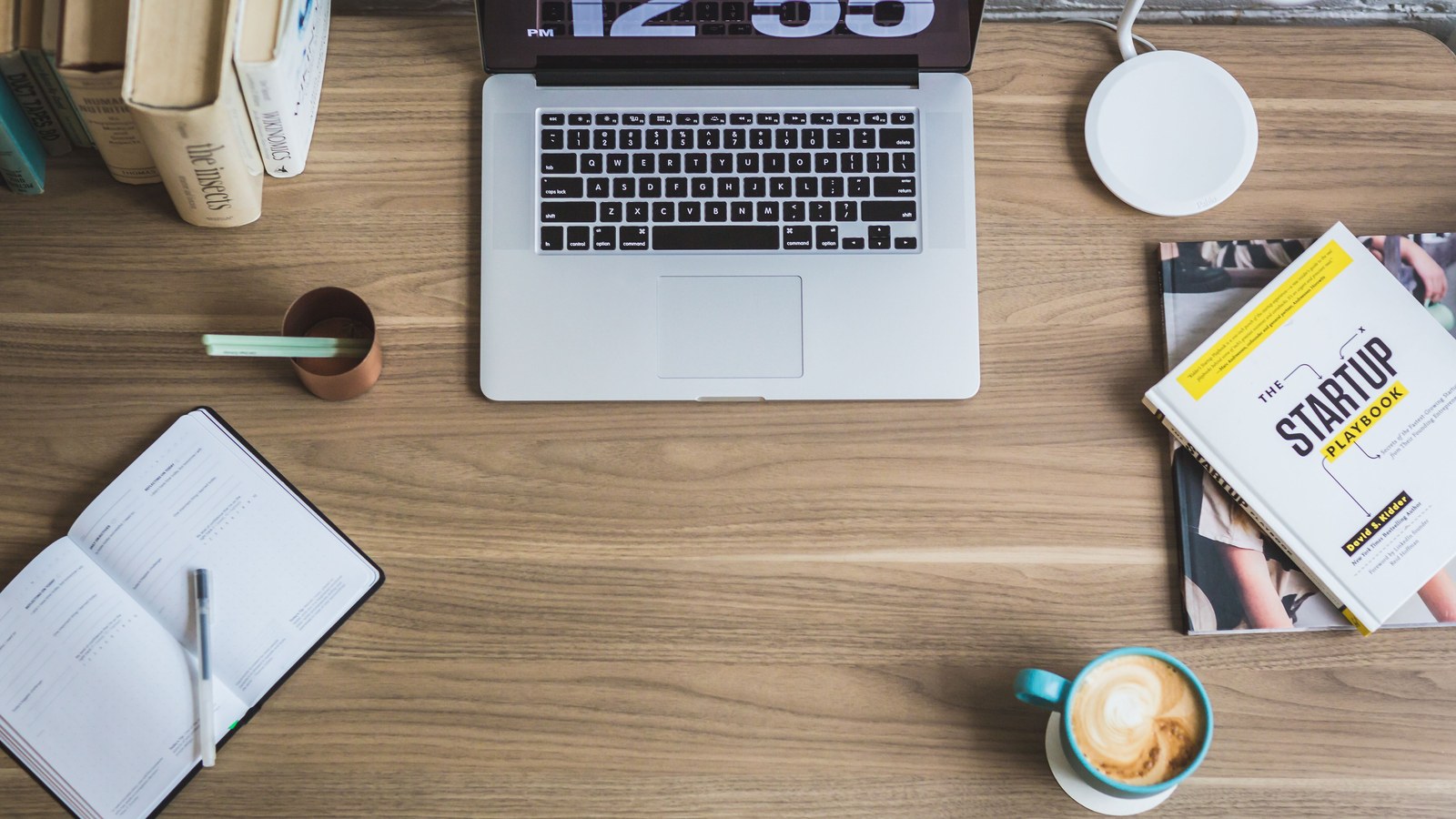 Laptop desk setup representing a UK home business testing demand before paying for branding.