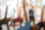 An instructor guiding the class through gentle movements.