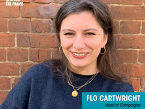A photo of Flo Cartwright, smiling warmly. She is wearing a navy blue blouse and standing in front of a brick wall. The Reclaim The Frame logo appears in the top left-hand corner. Text overlay reads: “Welcome Flo Cartwright – Head of Campaigns, Reclaim The Frame.”