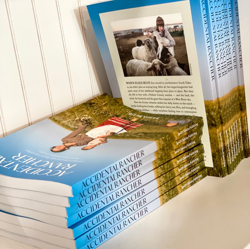 Available now! In South Dakota Magazine’s new book, Accidental Rancher, singer/songwriter Eliza Blue brings a musician’s grace to her observations of daily life on a Perkins County ranch — tending a menagerie of animals, wrangling two young children and finding appreciation for the simple beauty of the high plains.
Learn more about Blue on her website, www.elizablue.net.