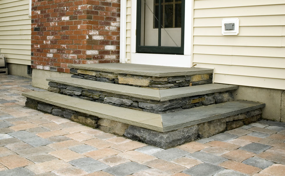 An Ideal Paver patio, with Goshen Stone walls, steps and fire pit with bluestone caps in Deerfield, MA