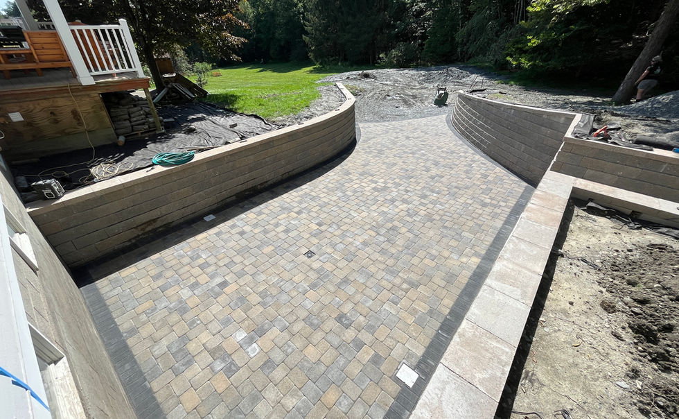 Ideal block retaining walls, and Ideal Paver patio with Granite Steps, landscape lighting and plantings in Bernardston MA