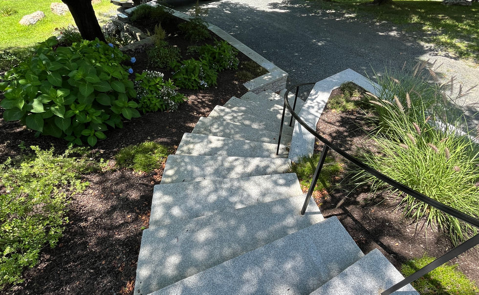 Granite veneered retaining walls and curved granite steps with custom railing, in Bernardston MA
