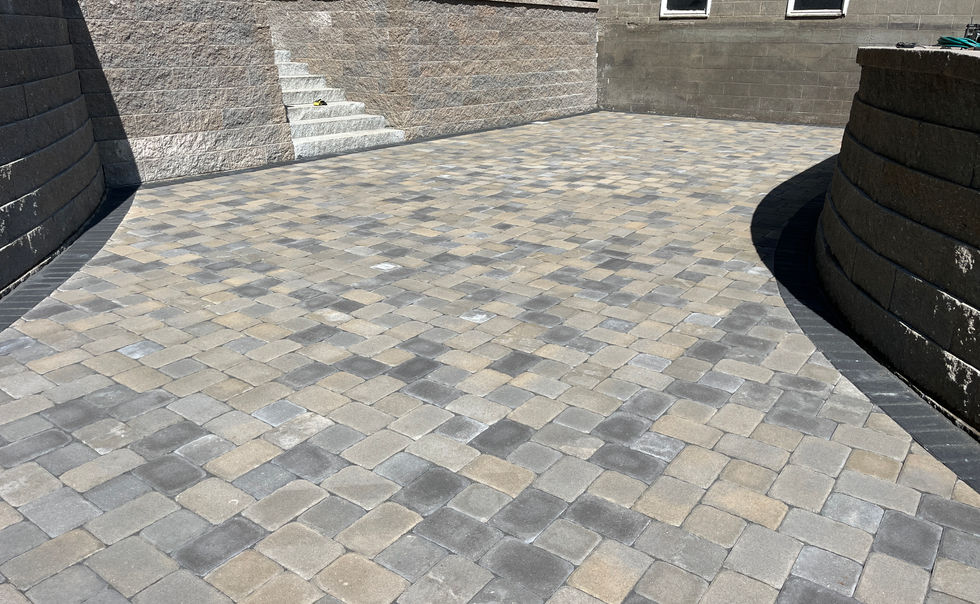 Ideal block retaining walls, and Ideal Paver patio with Granite Steps, landscape lighting and plantings in Bernardston MA