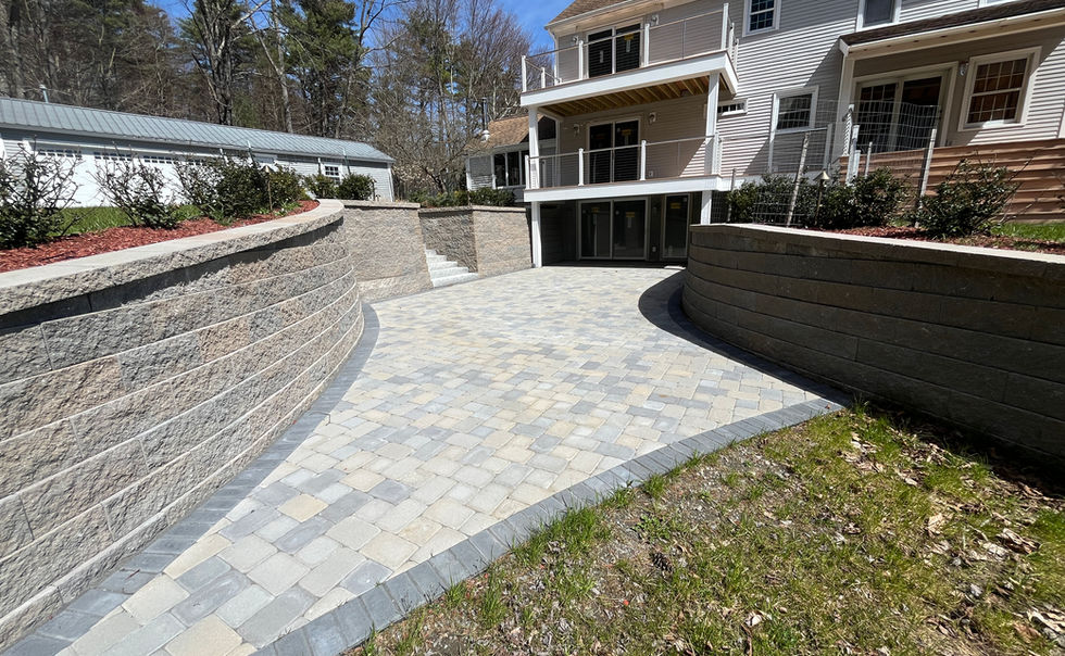 Ideal block retaining walls, and Ideal Paver patio with Granite Steps, landscape lighting and plantings in Bernardston MA