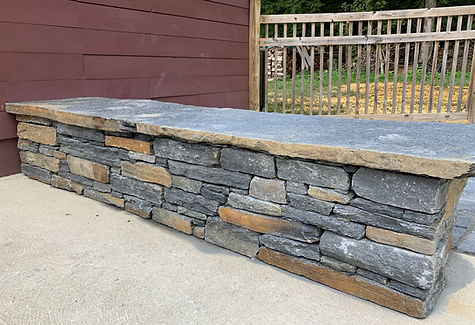 Ashfield Stone sitting wall and flagstone patio next to a pool in Greenfield, MA