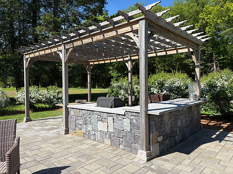 A patio project at NMH with Ideal Pavers, Granite out door kitchen and a wooden pergola, in Northfield, MA