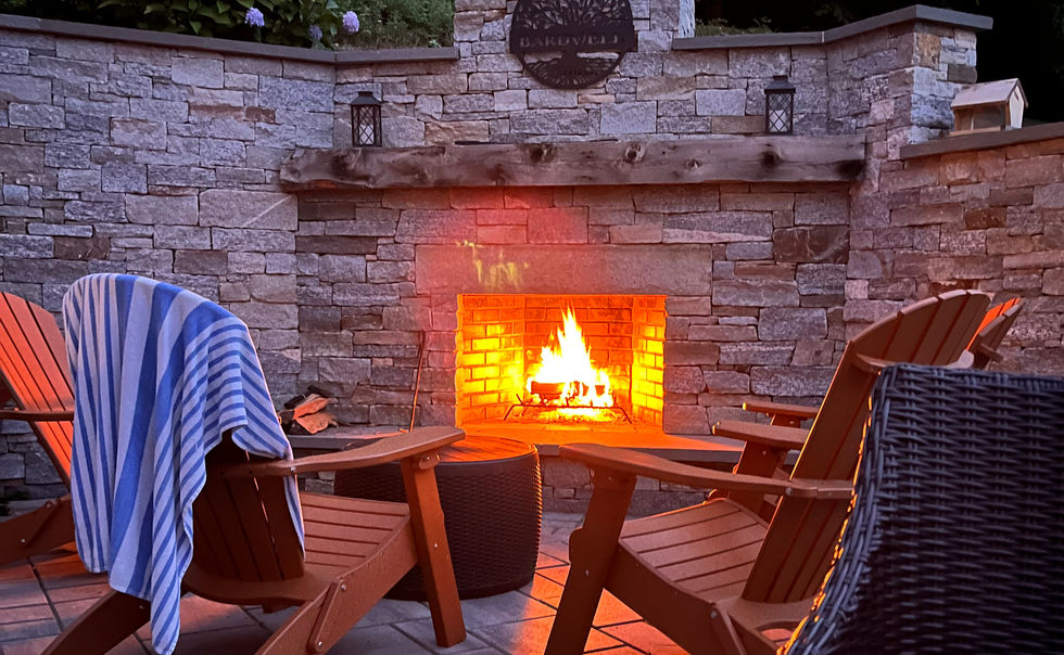 Natural granite stone outdoor fireplace on a patio in Shelburne Falls, MA