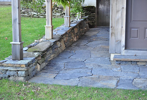 A Goshen Stone walkway entry with stone walls in Colrain MA