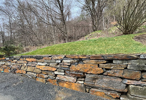 Large Goshen Stone retaining wall at a home in Buckland, MA