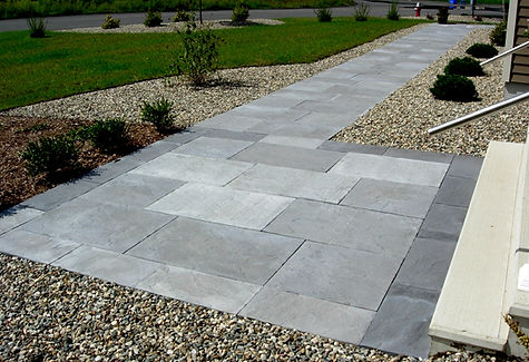 A modern landscape design with large slab paver walkway, and plantings in Turners Falls MA
