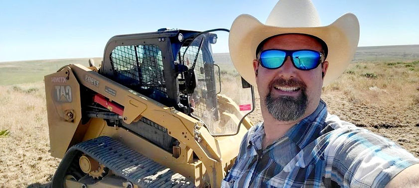 owner infront of a skidsteer