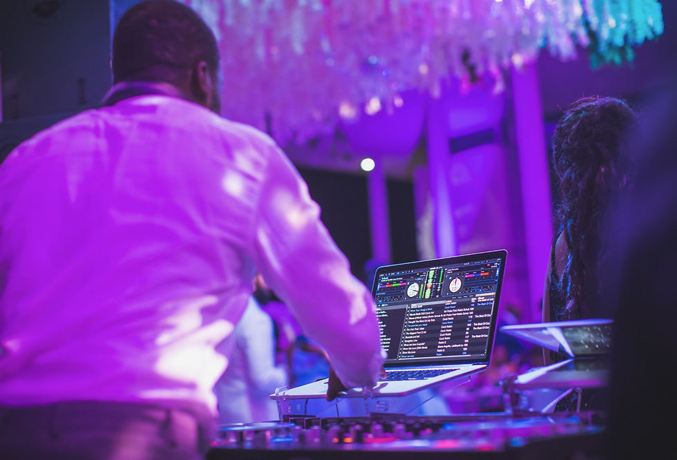 A lively wedding dance floor with a DJ and a 360 booth capturing slow-motion videos.