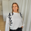 Thumbnail: 67536 Ecru trui met zwarte letters in strass 'Monari'