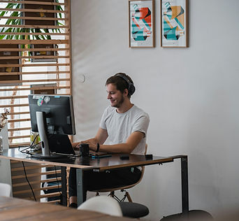 Man working on computer, sitting at his desk
