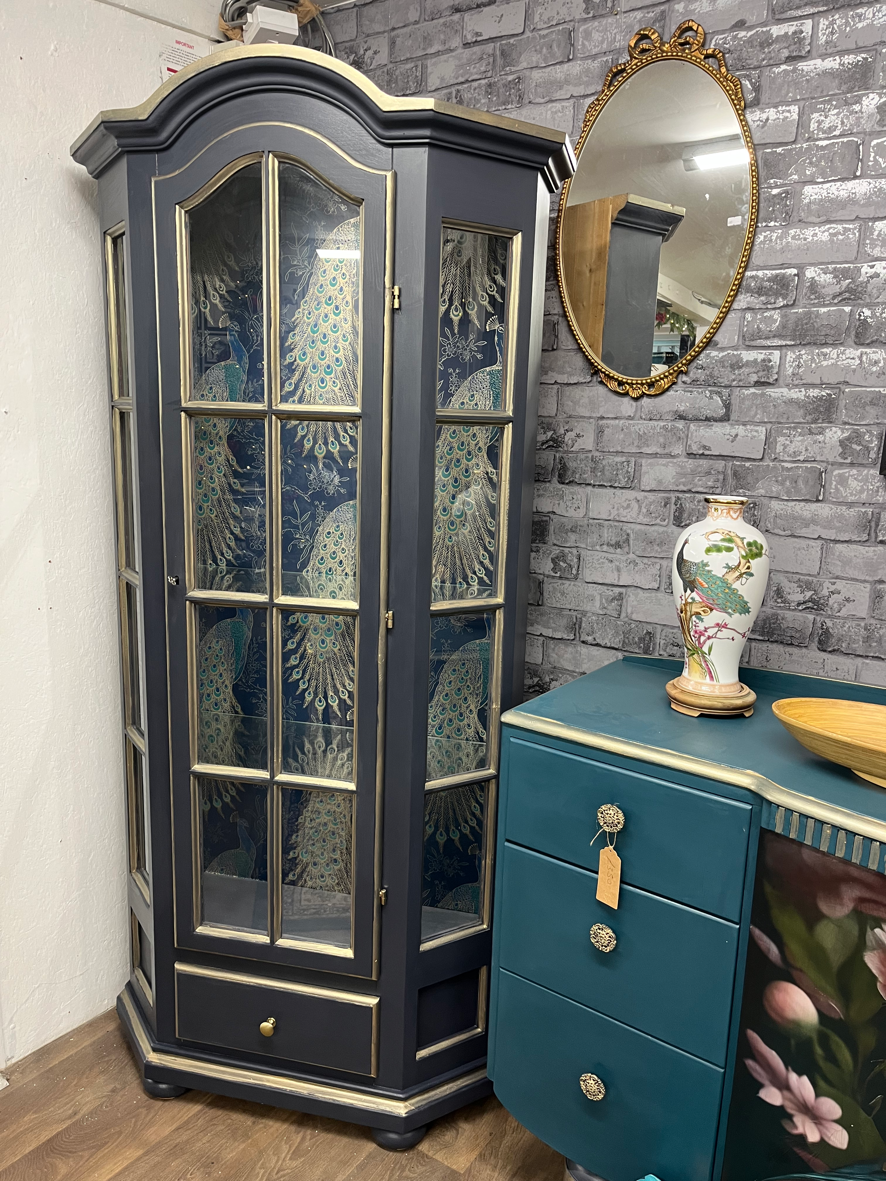 Dark blue and gold peacock themed glass cabinet
