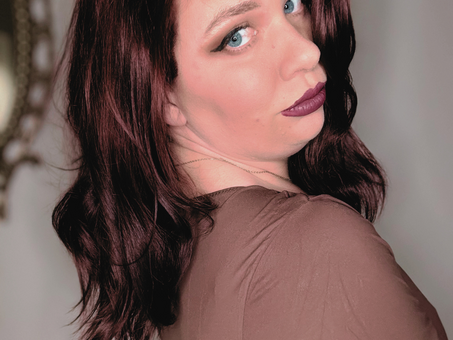 A woman turning towards the camera with her makeup done.