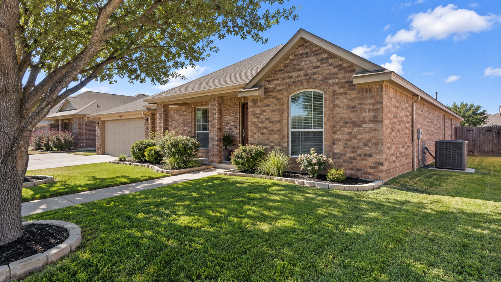 Brick home and maintained lawn being considered for a home and lawn plan property review