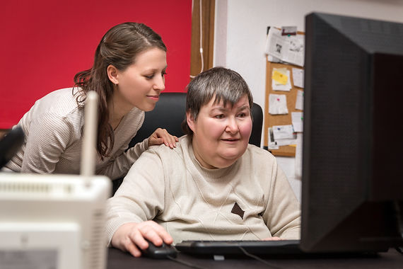 A lady learning to use a computer.