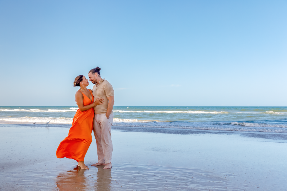 Couple posing for a photo on the beach in Daytona Beach Shores, Florida