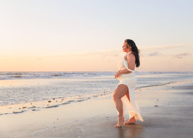 A lady posing for a sunrise photo on the beach in Daytona Beach Shores