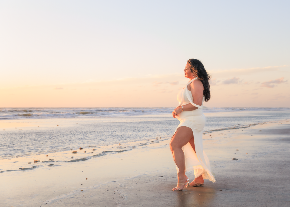 A lady posing for a sunrise photo on the beach in Daytona Beach Shores