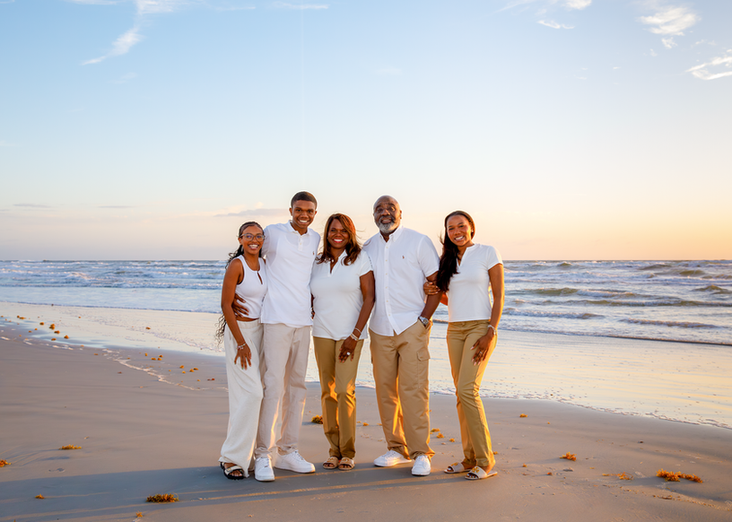 Family of 5 posing for family beach pictures in New Smyrna Beach, Florida