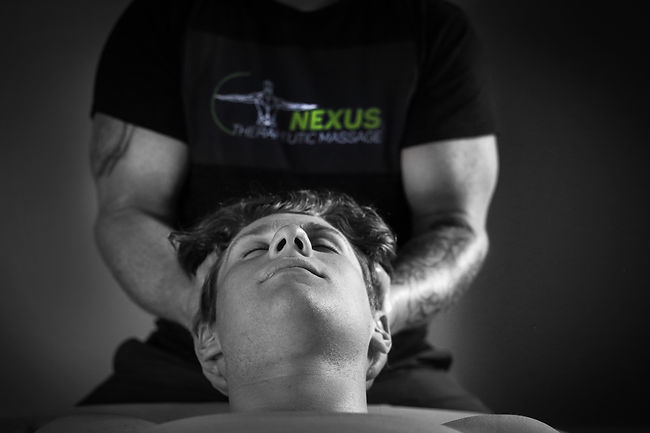 Massage therapist working on clients neck